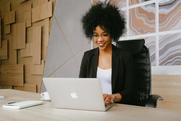 Woman Sitting at Computer Typing