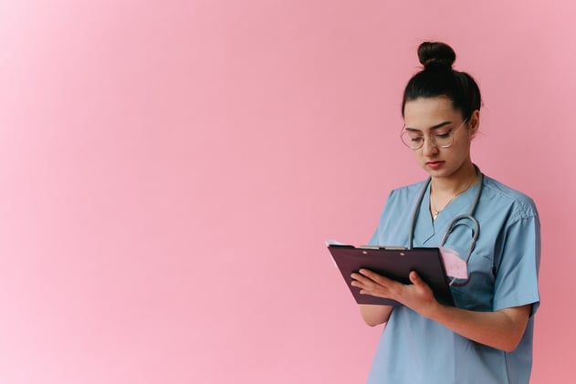 Woman in White Robe Holding Black Tablet Computer
