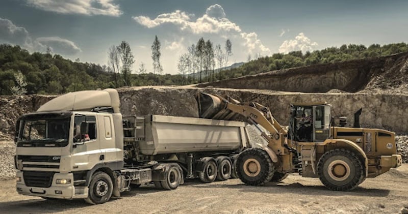 Truck and loader at construction site