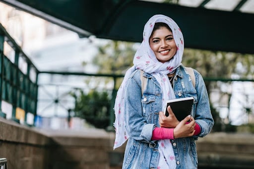Student Smiling with Notebook