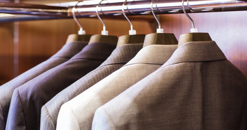 Suit coats hanging on a coat rack