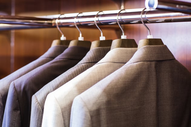 Suit coats hanging on a coat rack