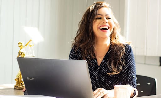 Woman at laptop smiling