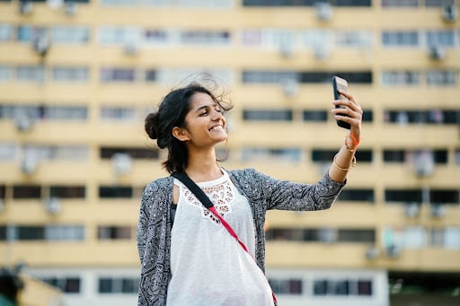 Smiling person taking selfie