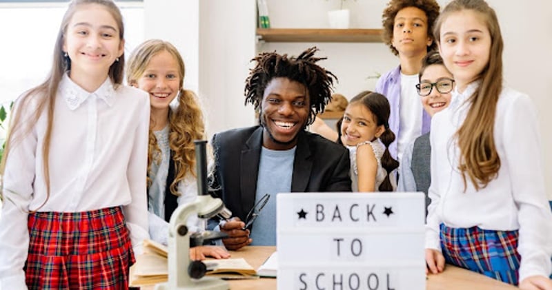 Teacher with students around desk