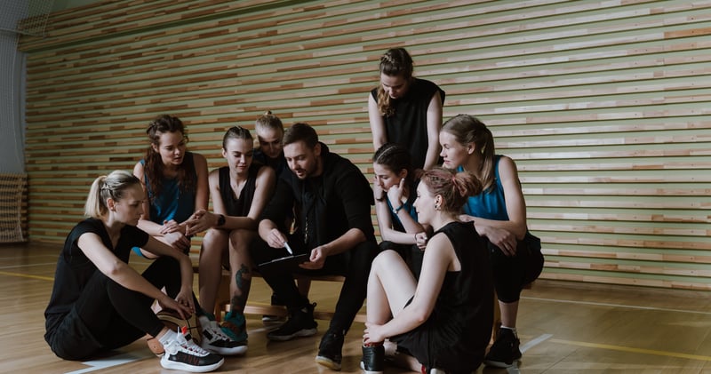 A Man Coaching a Team of Women