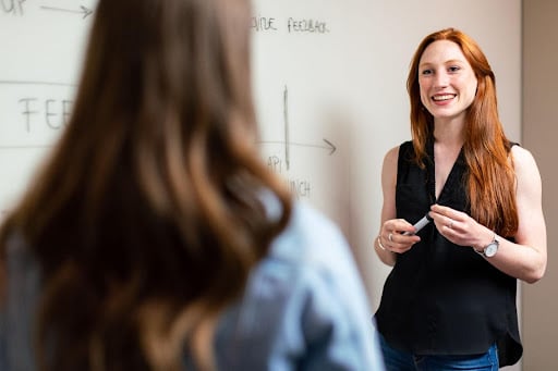 Teacher smiling at whiteboard