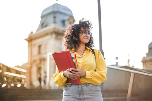 College student holding textbooks