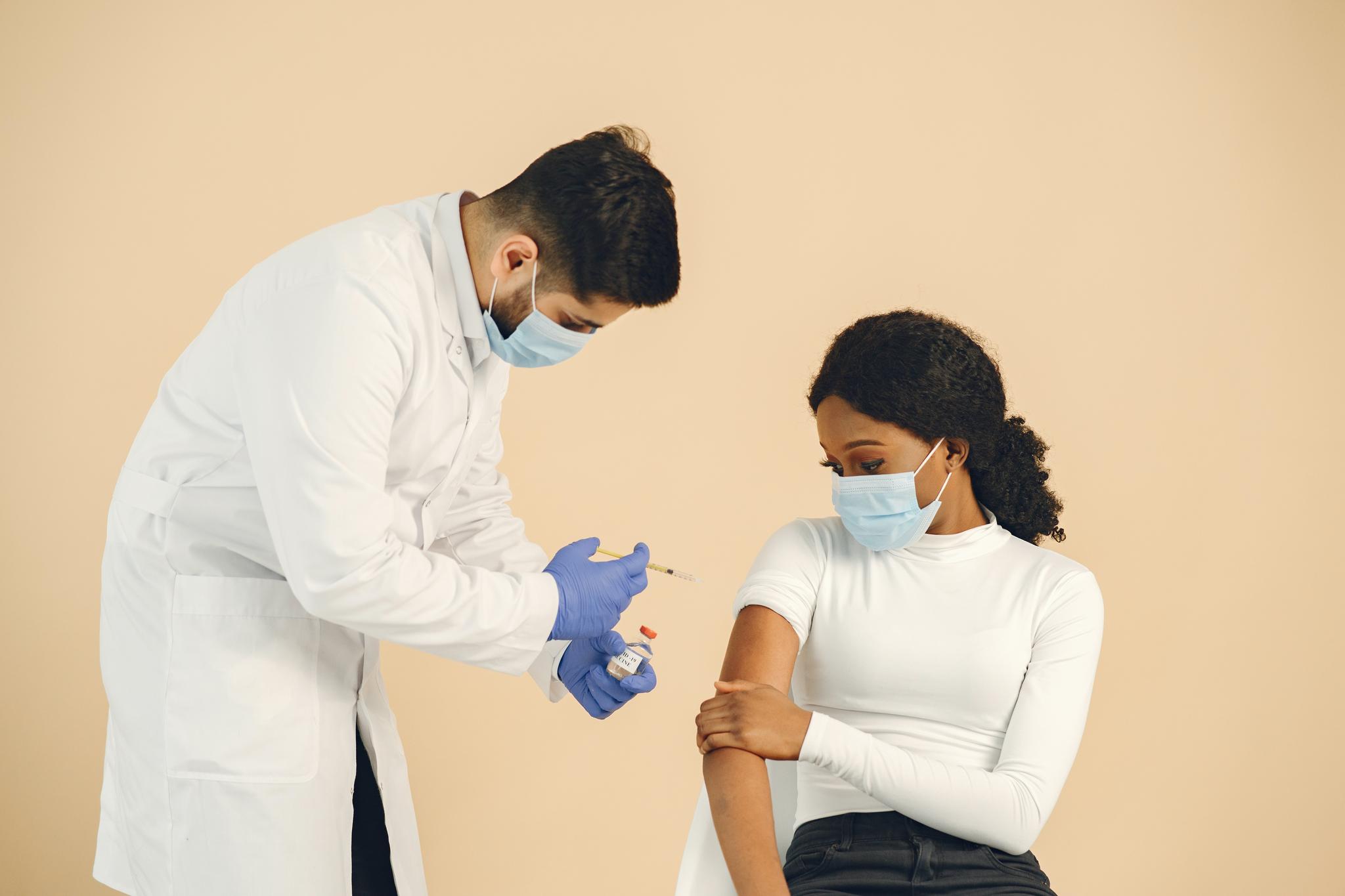 Man Vaccinating a Woman