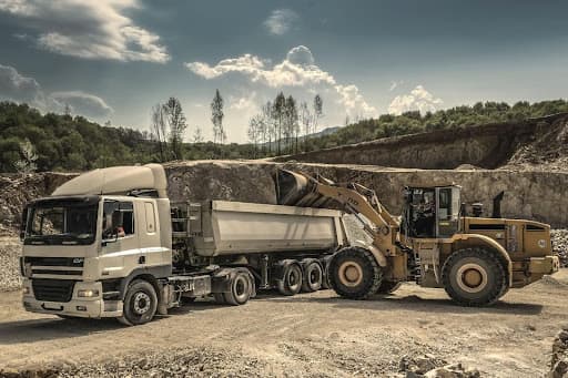 Truck and loader at construction site